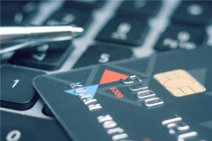 PCI Compliance Solutions - PCI DSS Services, pen and credit card Image